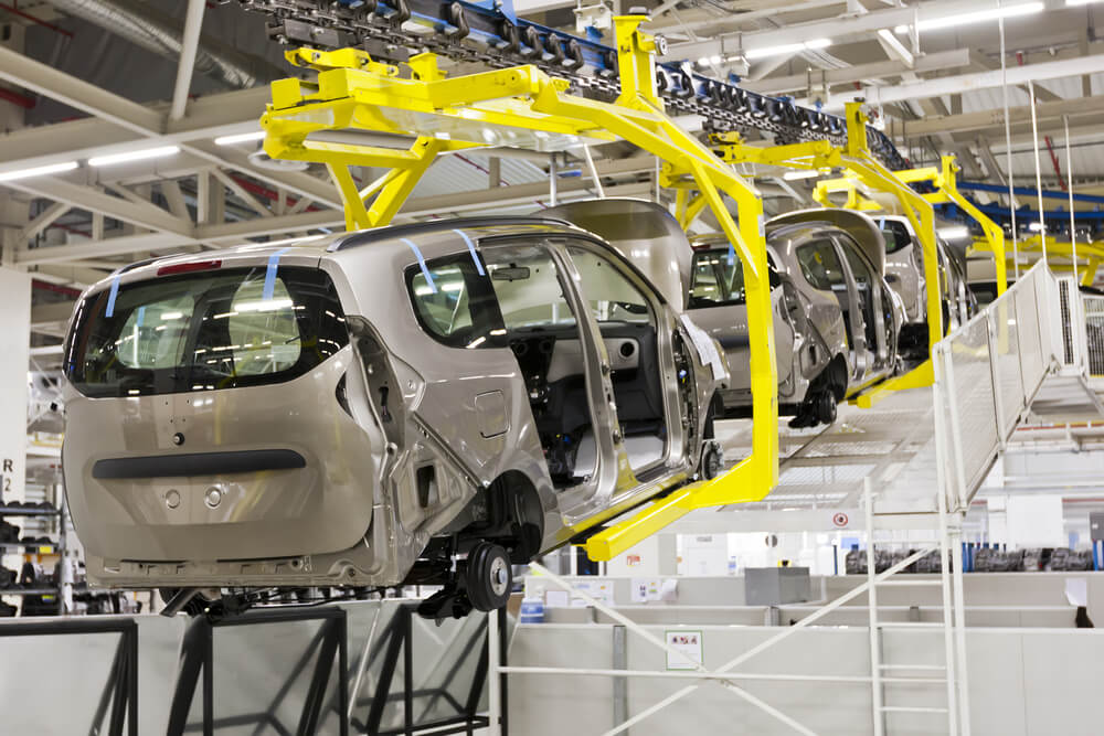 Cars on an assembly line.