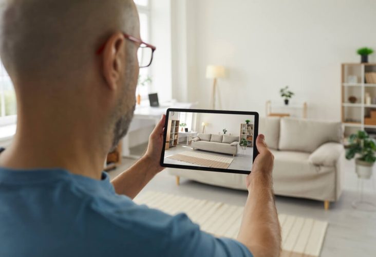 Man takes photos of his home furnishings in order to do a home inventory for renters insurance.