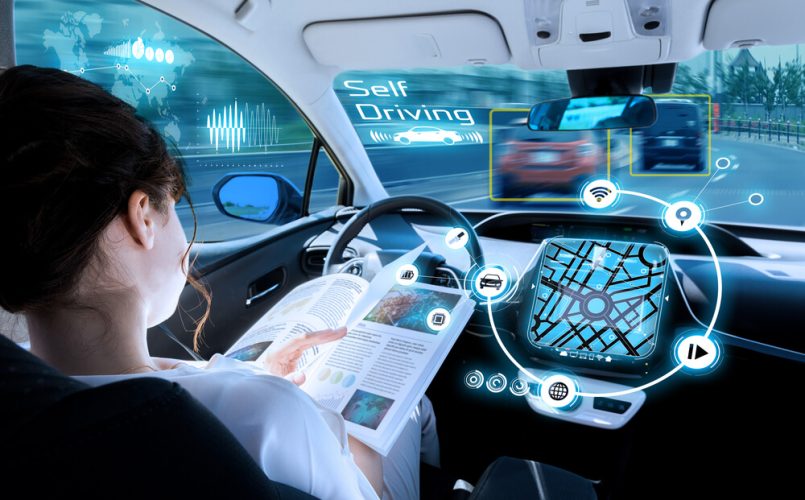Woman reading a magazine carefreely as her car drives itself - Freeway, Cheap car insurance