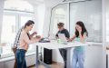 Group of independent contractors share the Wi-Fi in a shared work space - affordable health coverage for independent contractors in California.