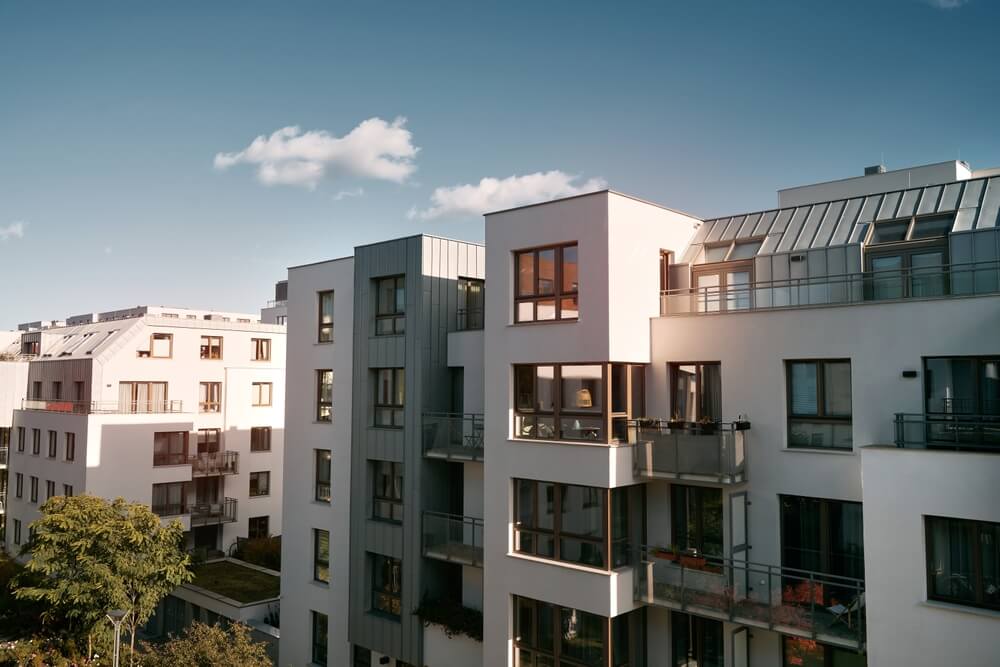 An apartment complex with a blue sky. - cheap renters insurance.