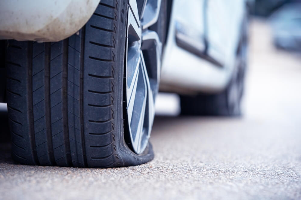 This image has an empty alt attribute; its file name is freeway-how-to-change-a-flat-tire-2.jpg