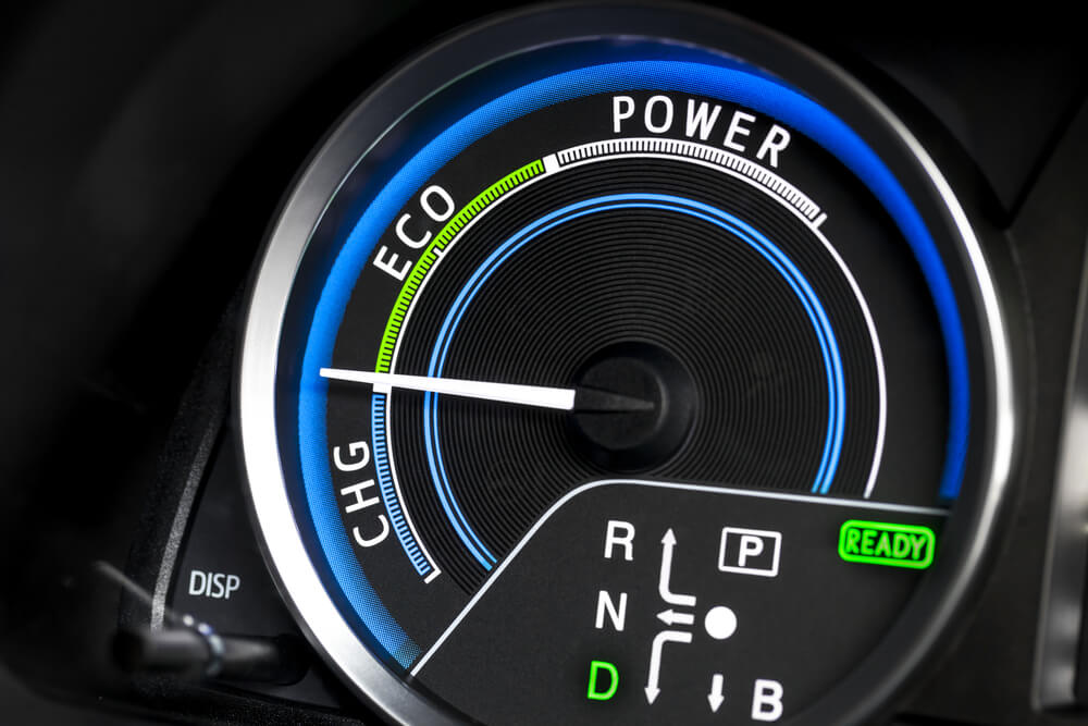 A picture of a vehicle's gauges, showing the different statuses of hybrid and electric - cheapest car insurance.