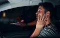 Young man driver gets pulled over by the police at night.