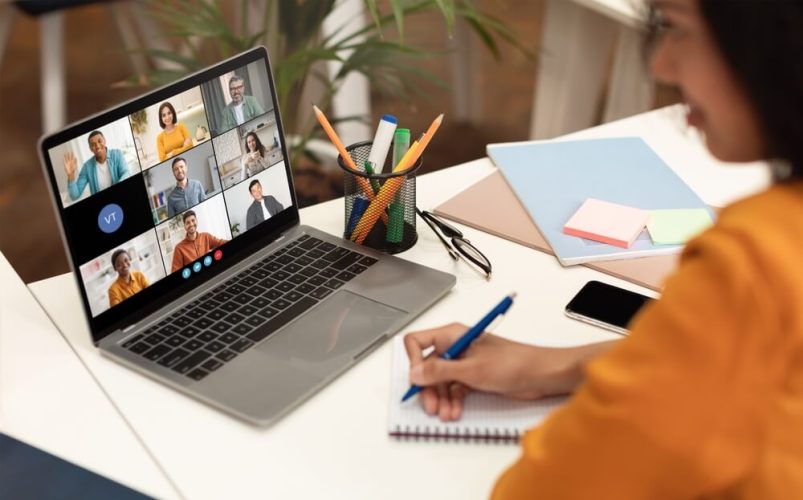A female remote employee joins a call with her colleagues on her laptop from home - cheap home insurance.