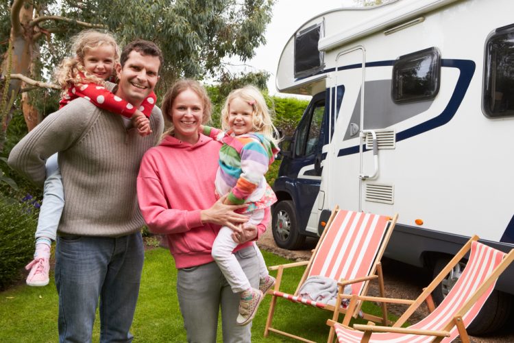 Family plays outside RV.