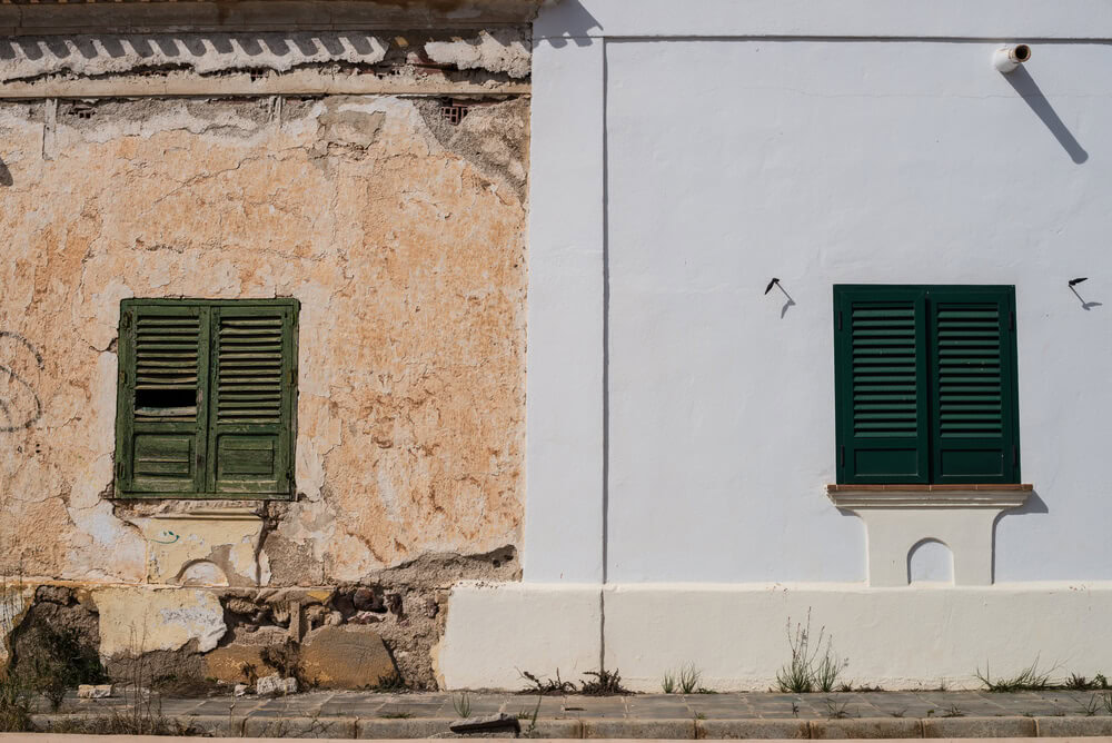 Two walls side by side, one in disrepair the other remodeled - cheap home insurance.