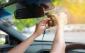 Hands installation front dashcam to help record incidents on the road, insurance claims with a dashcam.