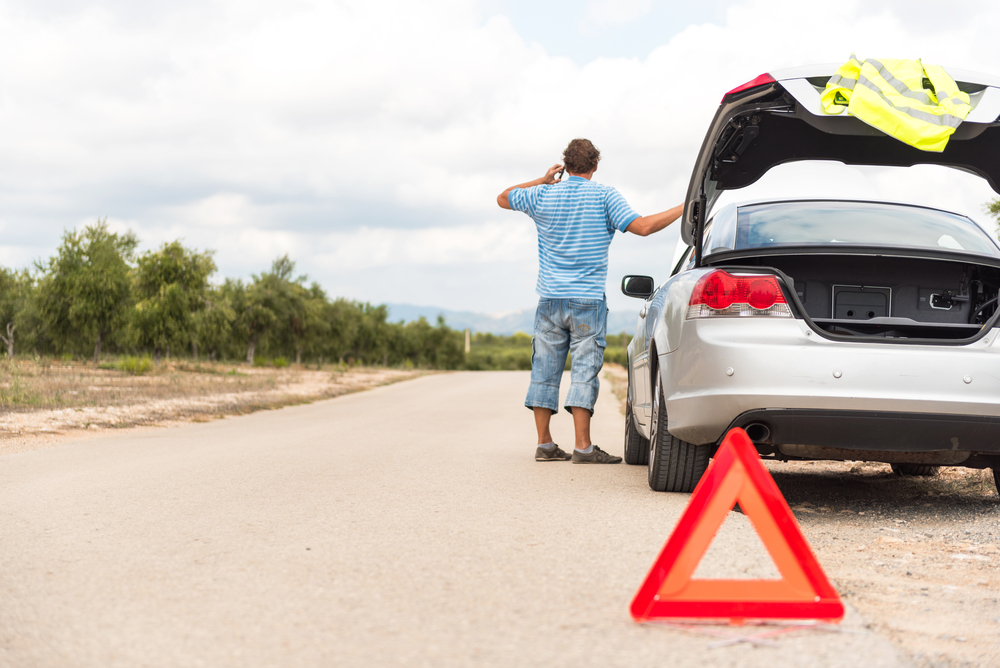 Man calls his auto club for roadside assistance after his car breaks down.