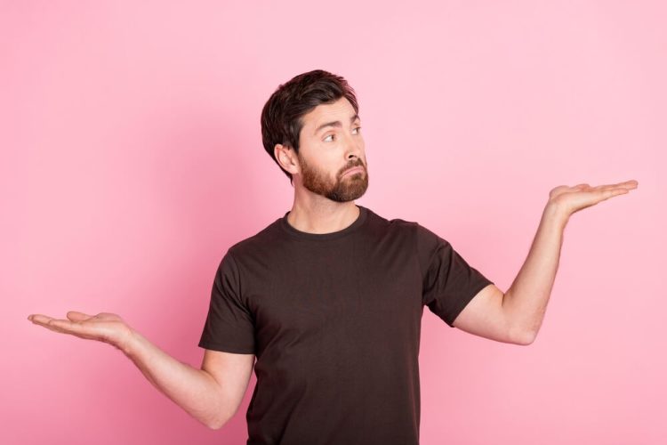 Portrait of man with stylish bristle wear brown shirt arms comparing liability and full coverage car insurance, which is best?