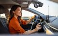 Woman turning on car air conditioning system, which uses more gas, car air conditioner on off button.