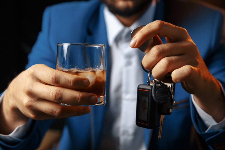 A guy drinking holding his keys about to drive and needing sr-22 insurance.