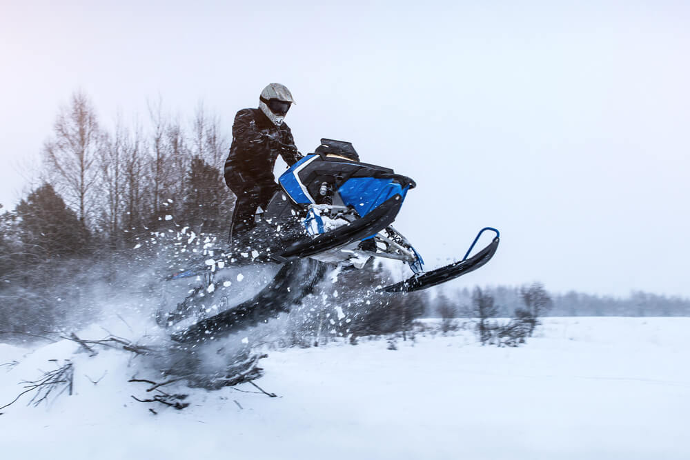 Snowmobile in action. Active winter holidays