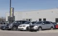 Rows of pre-owned cars lined up at a dealership lot in Indianapolis, illustrating demand for vehicles and used car insurance shopping considerations.
