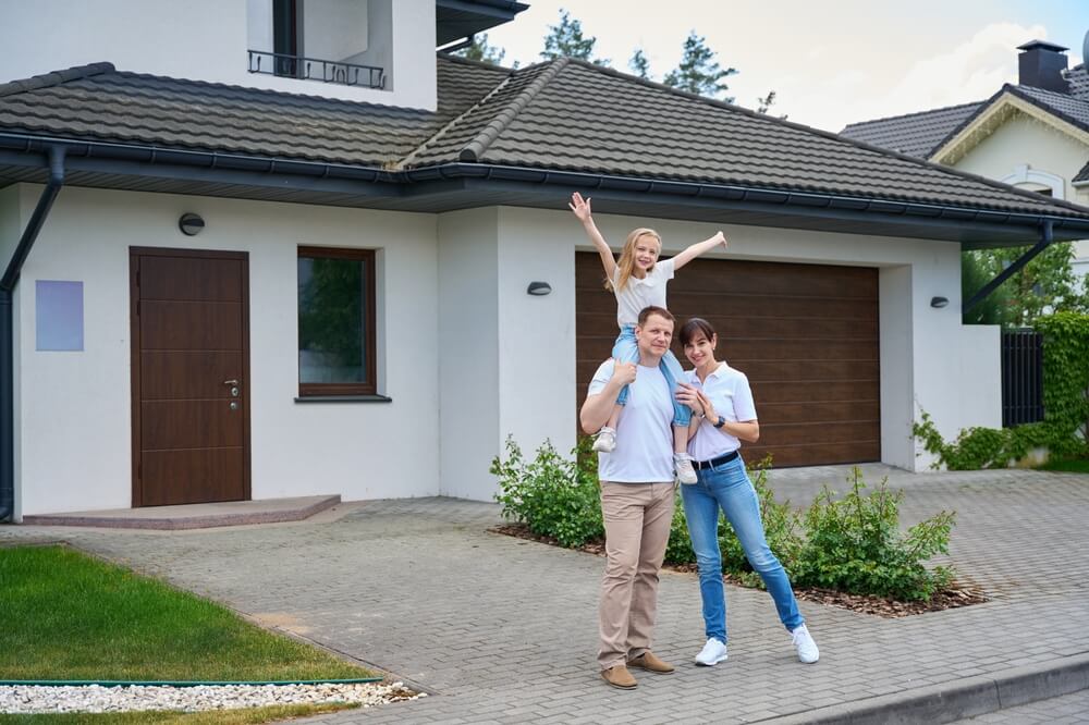 Family standing in front of their home, illustrating what an escrow is in a home buying process.