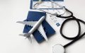 Passport, boarding pass, and medical equipment representing Covered California coverage for urgent care and medical emergencies while traveling out of state.