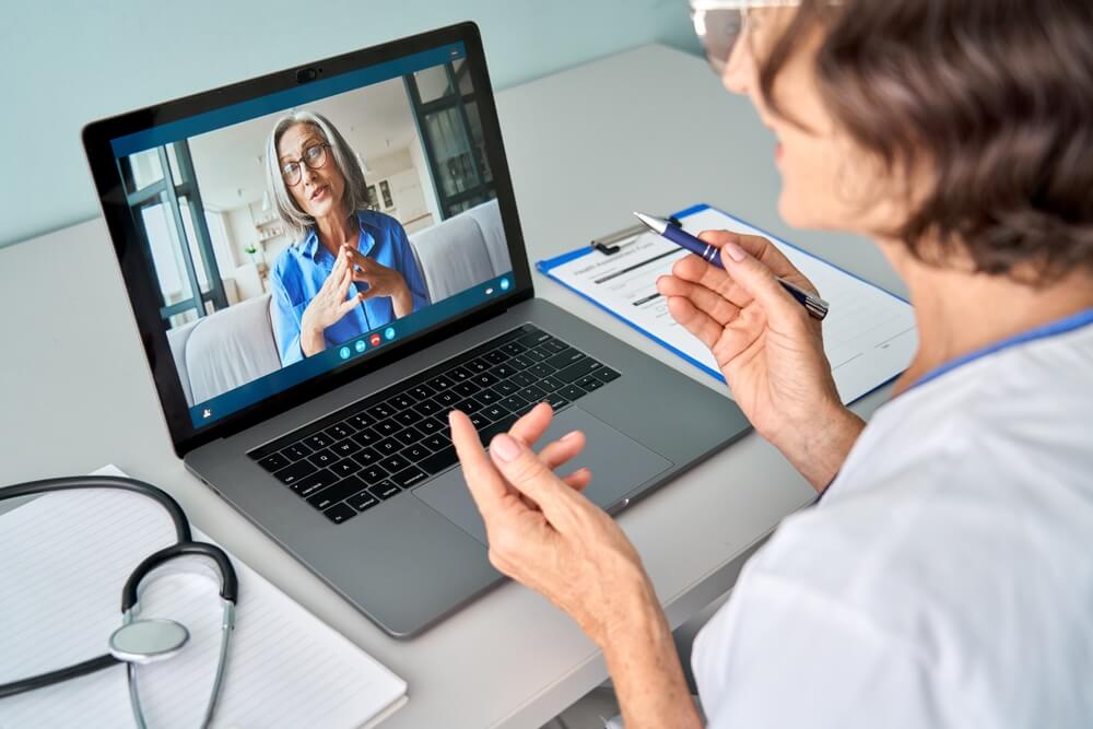 Healthcare provider conducting a telehealth virtual care Covered CA video consultation, discussing treatment options and providing remote care to a patient.
