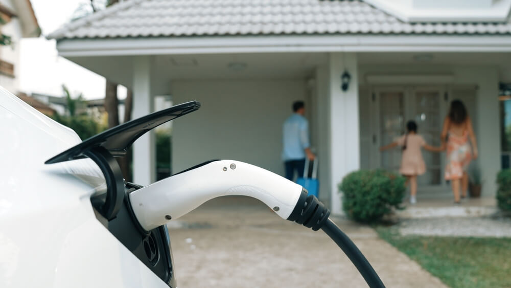 EV charging at a family home, illustrating how home insurance may relate to EV charger installation.