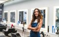 Salon beauty professional standing at her workstation with hair styling tools.