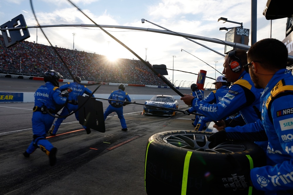 NASCAR pit crew services a race car during a pit stop at Darlington Raceway.