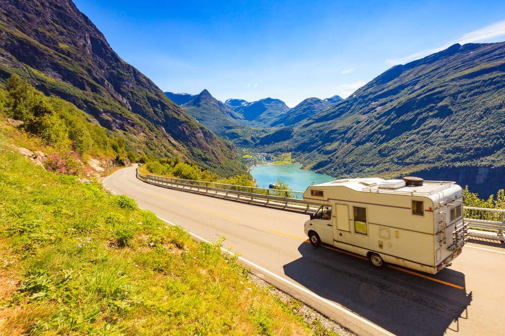 Motorhome traveling on a mountain road for drivers looking to compare RV insurance.