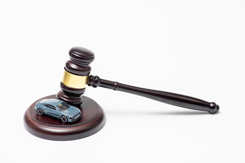 Judge’s gavel resting beside a toy car, representing SR-22 insurance requirements.