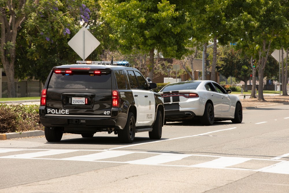 Police SUV conducting a traffic stop, illustrating how officers can check a driver's car insurance status.