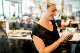 Portrait of executive businesswoman with office in the background.