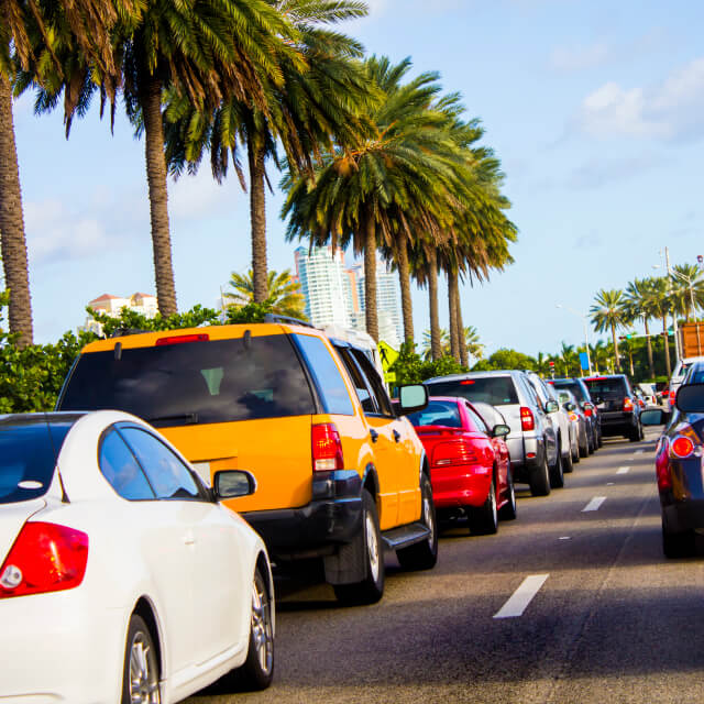 Photo of a road to Miami Beach, Florida with dozens of cars stuck in traffic.