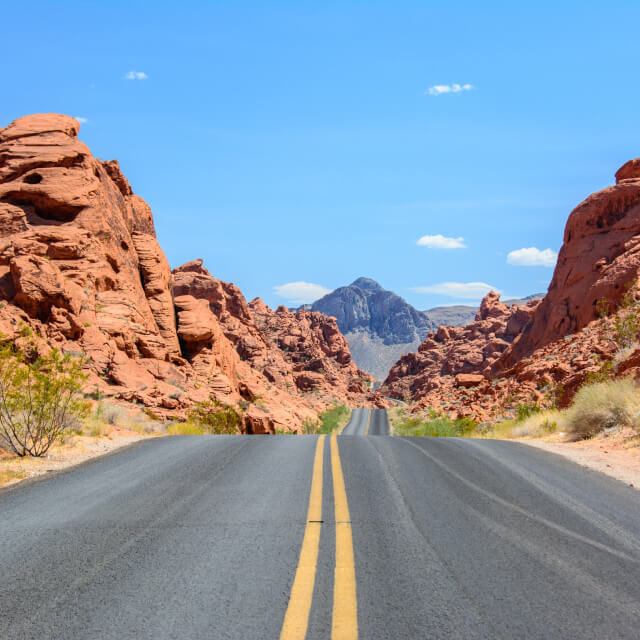 Photo of a highway street running through the desert in the Valley of Fire, Nevada.