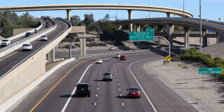 Picture of a highway crossroad in Phoenix, Arizona, showing bridges in different heights and a busy main road.