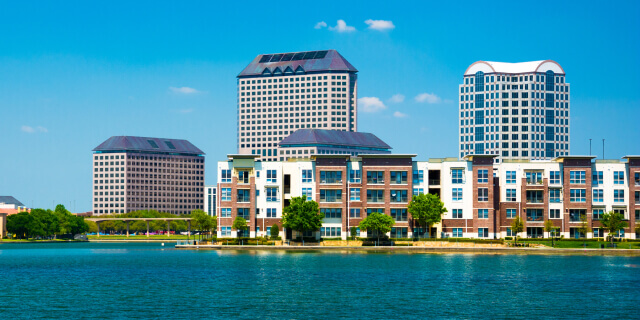 Skyline of the Las Colinas area of Irving, Texas with a lake in the foreground