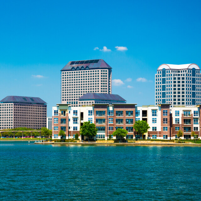 Skyline of the Las Colinas area of Irving, Texas with a lake in the foreground