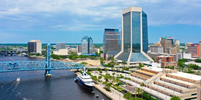 Aerial view of downtown Jacksonville skyline with bridge and river