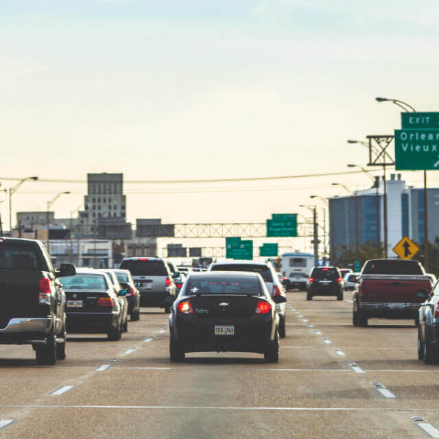 Photo of traffic on a highway in Louisiana with a sign that reads Orleans.