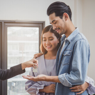 Young happy couple getting house keys.