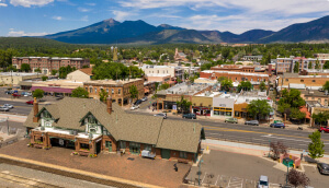 Route 66 through Flagstaff, AZ with mountains in the distance