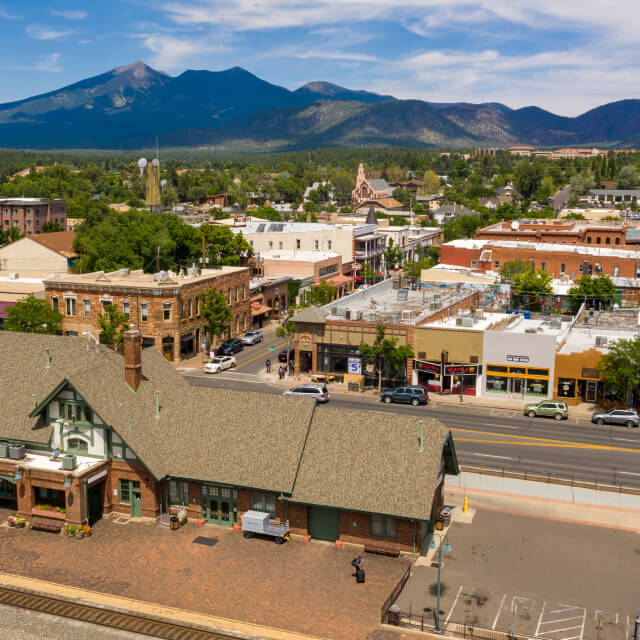 Route 66 through Flagstaff, AZ with mountains in the distance