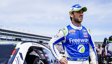 NASCAR Cup Series Driver and Xfinity Series Champion Daniel Suarez in the stadium posing with Freeway Sponsored Chevrolet race car