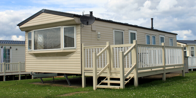 Mobile Home in a yard with other mobile homes in the background