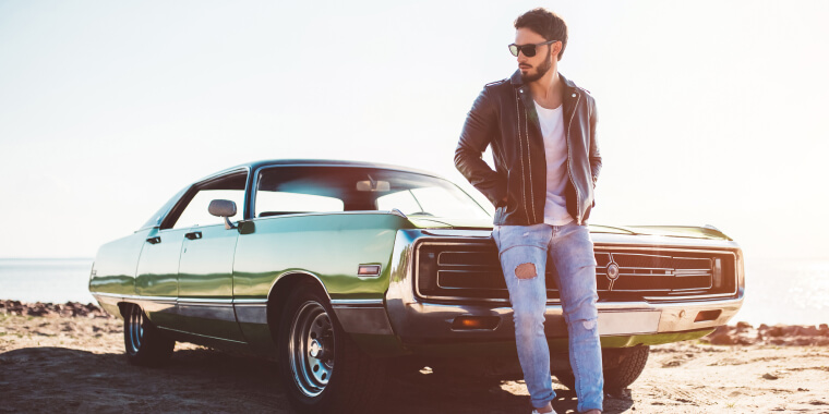 Man standing in front of classic car