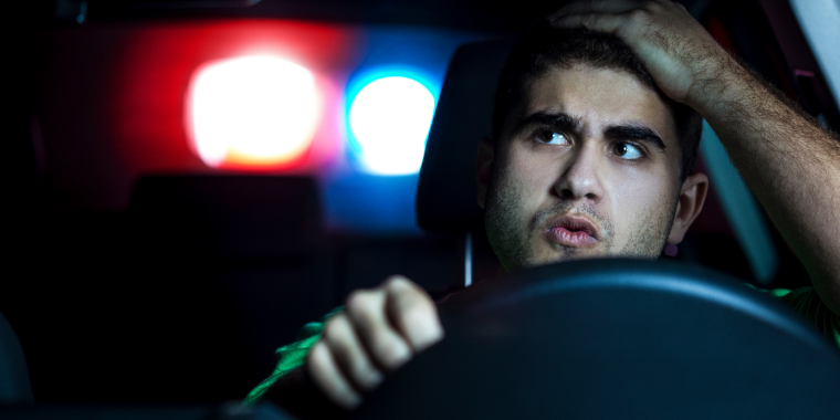 Police detaining a driver at night