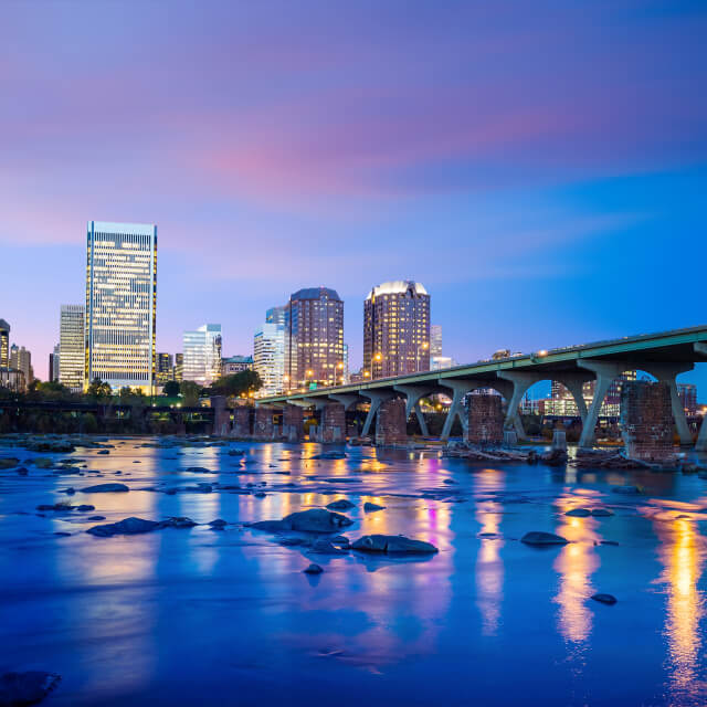 Downtown Richmond, Virginia skyline and the James River at twilight.