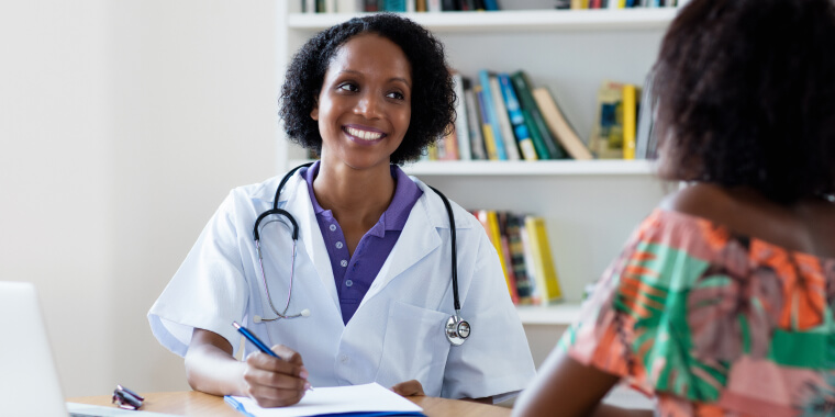 African american female doctor speaking to a patient in hospital