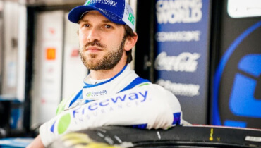 Daniel Suarez leaning on car