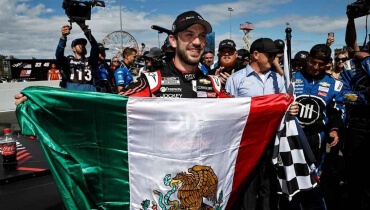 Daniel Suarez celebrates after win holding Mexican flag