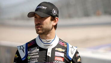 NASCAR driver, Daniel Suarez stands on track