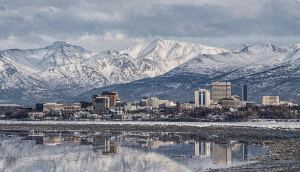 Reflection of Anchorage in the water with mountains in background