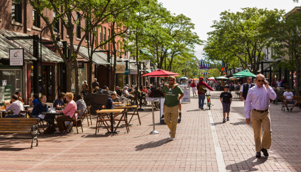 People on Church Street in Burlington, VT, a pedestrian mall with sidewalk cafes and restaurants.