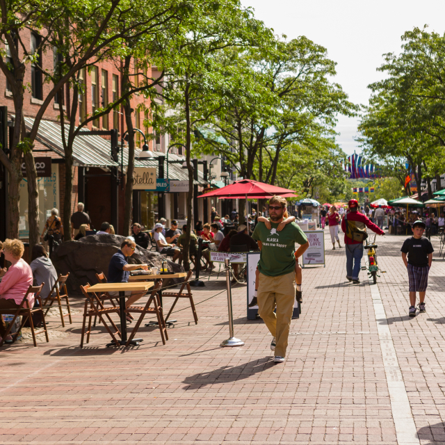 People on Church Street in Burlington, VT, a pedestrian mall with sidewalk cafes and restaurants.